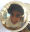 My face reflected in a doorknob.