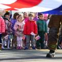 Children watch as Westwood firefighters fold the American flag after an annual Veterans Day Remembrance Ceremony at the Westwood Veterans Memorial Wall on Friday, Nov. 11, 2016.